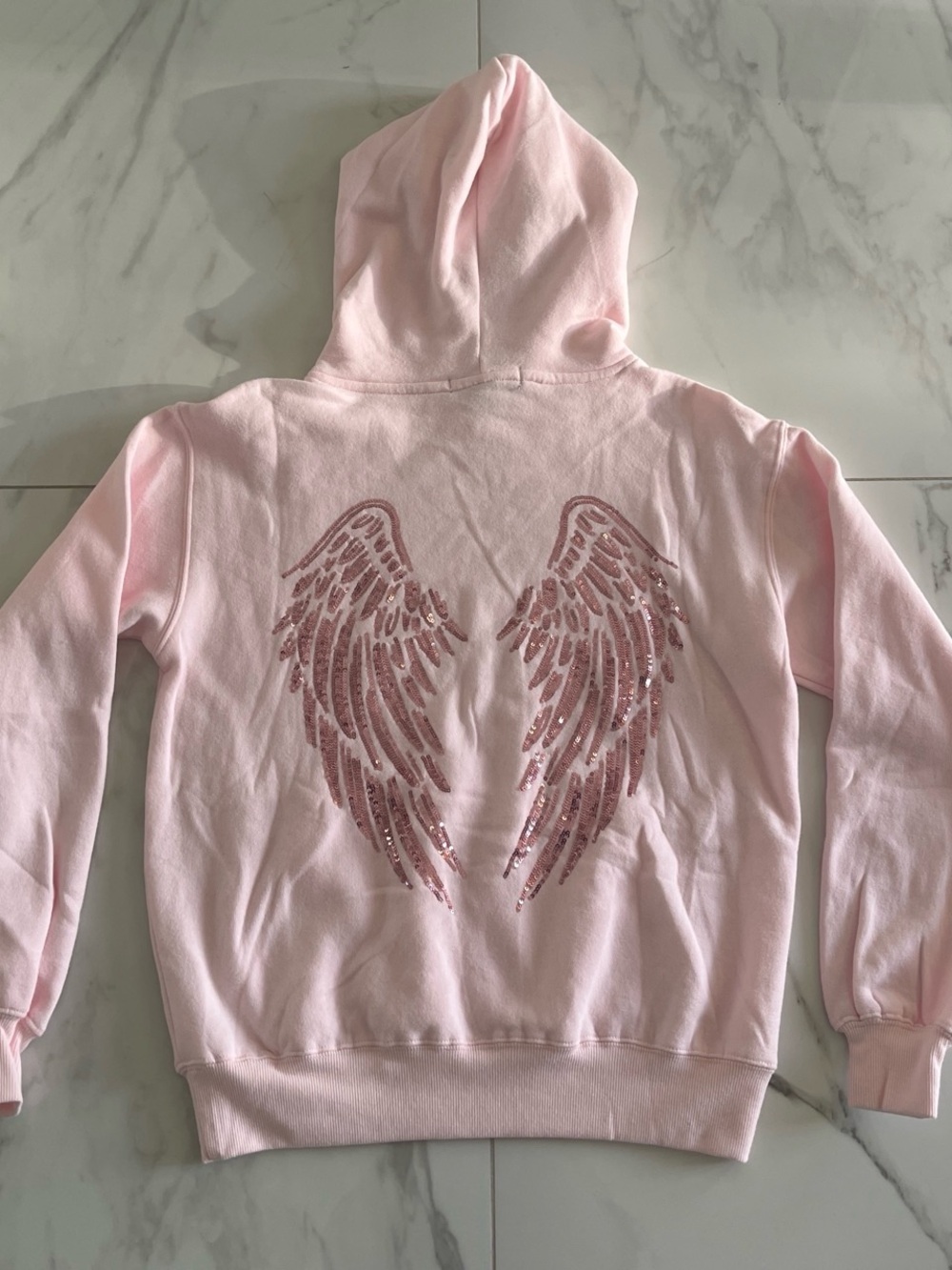 Light pink angel wing hoodie with sequins wings on back.